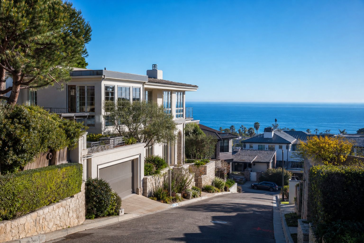 Contemporary luxury home on compact coastal bluff lot in La Jolla with Pacific Ocean visible beyond.