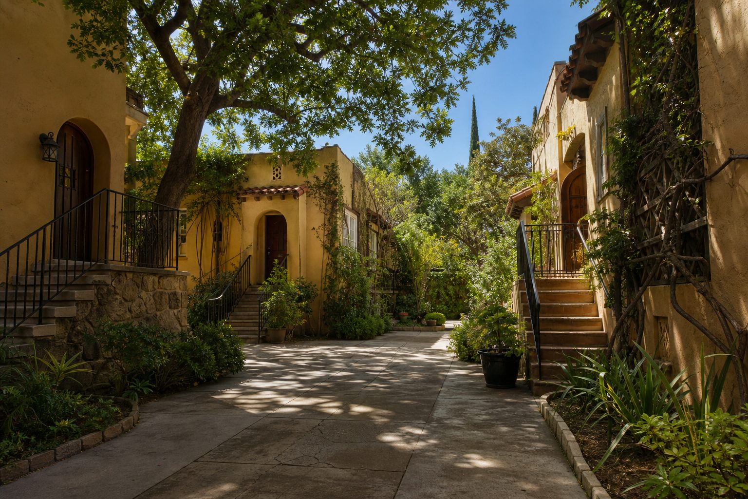 Multi-unit courtyard triplex in North Park with shared garden and traditional Mediterranean architecture during morning light.